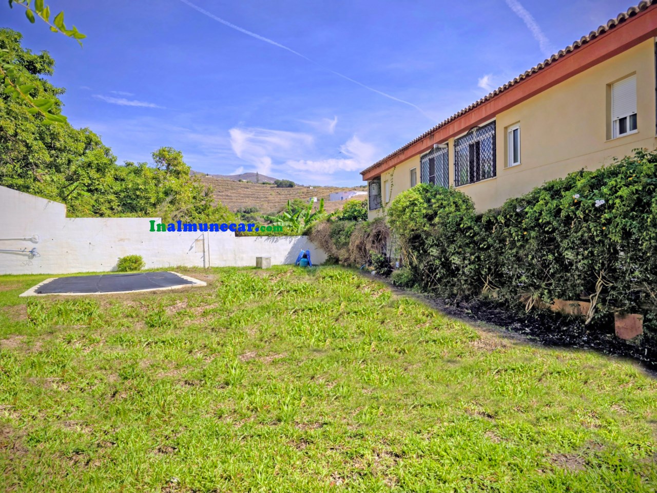 Radhus till salu i urbaniseringen med pool och stängt garage.